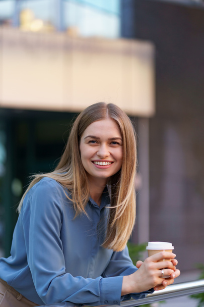 Charismatic woman drinking coffee to go at work - Photo, Image