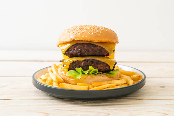 hamburger or beef burgers with cheese and french fries - unhealthy food style - Фото, изображение