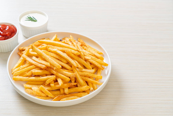 French fries or potato chips with sour cream and ketchup - Foto, Imagem