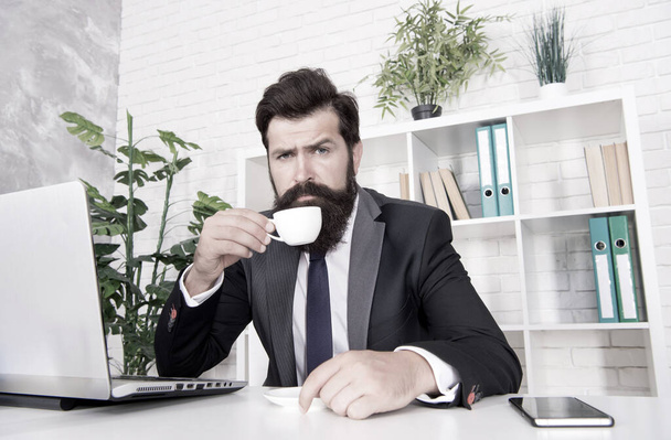 Comfy workspace. Bearded hipster formal suit relaxing with coffee. Office life is unthinkable without good coffee. Reception room. Respectable ceo. Man handsome boss sit in office drinking coffee - Foto, imagen