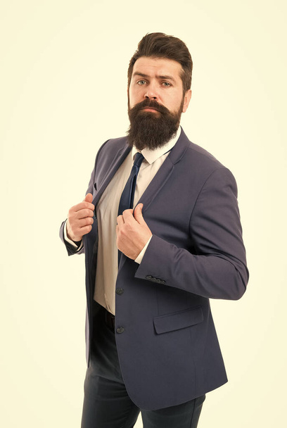 Modern businessman ofiice worker. Office life concept. He knows who is boss here. Bearded man confident posture isolated white. Hipster with beard formal suit office worker.Businessman formal suit - Zdjęcie, obraz