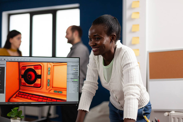 Πολυεθνική σχεδιαστής γυναικών κοιτάζοντας υπολογιστή με διπλή οθόνη που εργάζονται μαζί - Φωτογραφία, εικόνα