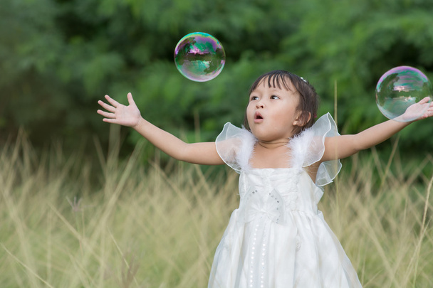 Kid playing with soap bubbles. - Photo, Image