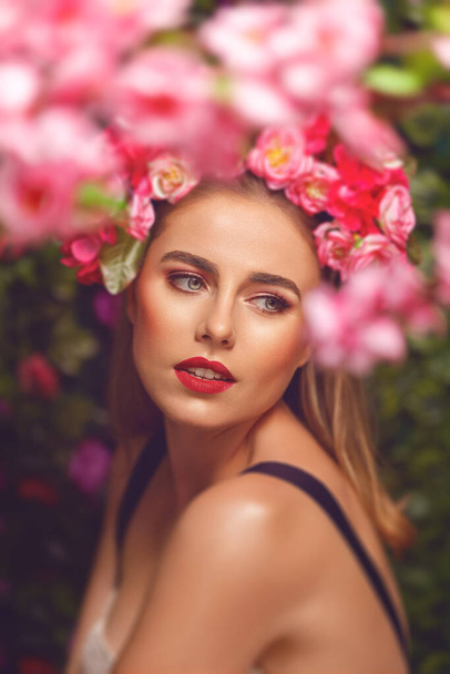 Beautiful young woman beauty and fashion portrait with wreath headband in flowers garden - Photo, Image