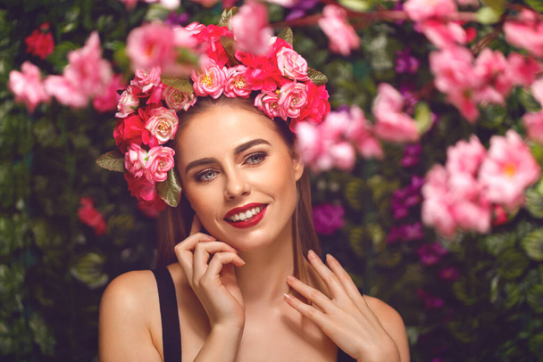 Beautiful young woman beauty and fashion portrait with wreath headband in flowers garden - Foto, afbeelding