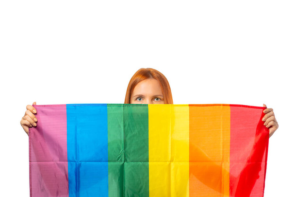 Lesbian woman holding rainbow flag isolated on white background. LGBT International symbol of the lesbian, gay, bisexual and transgender community. - Photo, image