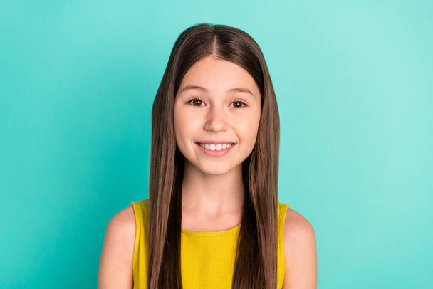 Photo of optimistic nice brown hair girl wear yellow dress isolated on bright teal color background - Foto, Imagem