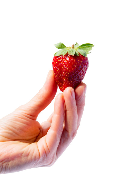 Hand holding a strawberry - 写真・画像