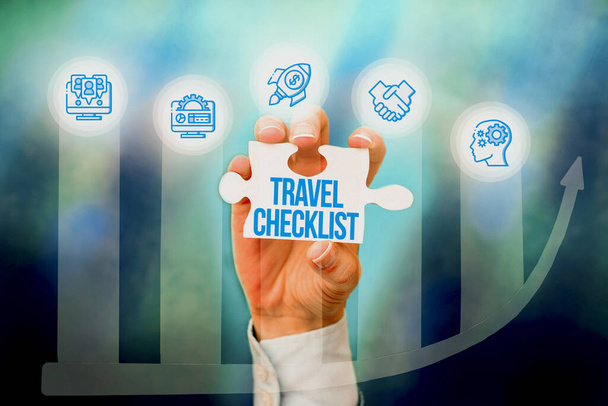Hand writing sign Travel Checklist. Word for a list of things to be checked or done for the planned trip Hand Holding Jigsaw Puzzle Piece Unlocking New Futuristic Technologies. - Photo, Image
