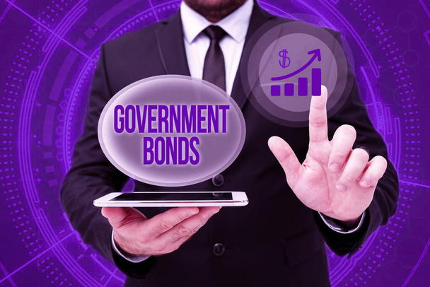 Text sign showing Government Bonds. Business overview debt security issued by a government to support spending Man In Office Uniform Standing Pressing Virtual Button Holding Tablet. - Photo, Image
