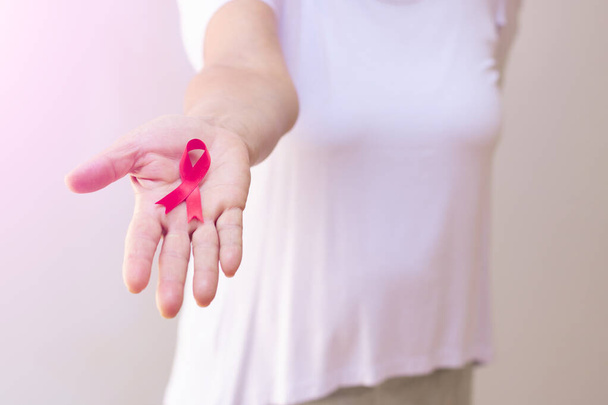 Mulher madura com uma fita rosa isolada no branco. Conscientização do Câncer de Mama Imagem do mês.  - Foto, Imagem