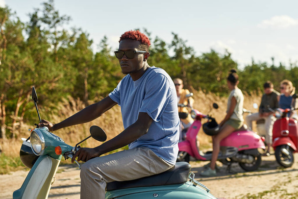Bello giovane uomo africano americano su scooter retrò - Foto, immagini