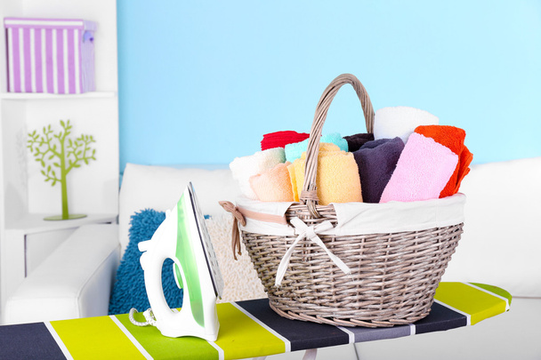Basket with laundry and ironing board - Photo, image