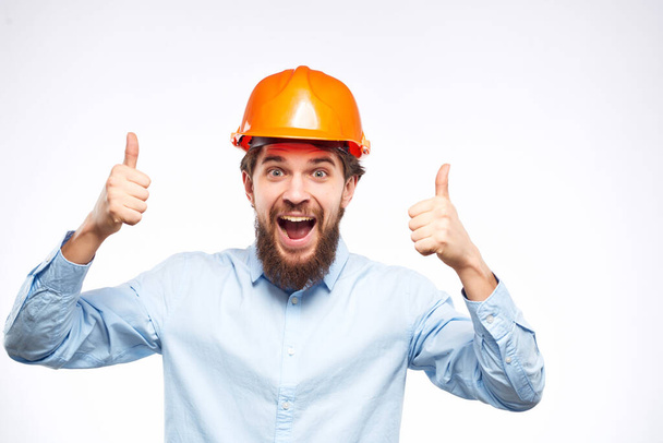 emotional man orange helmet on the head success isolated background - Photo, image