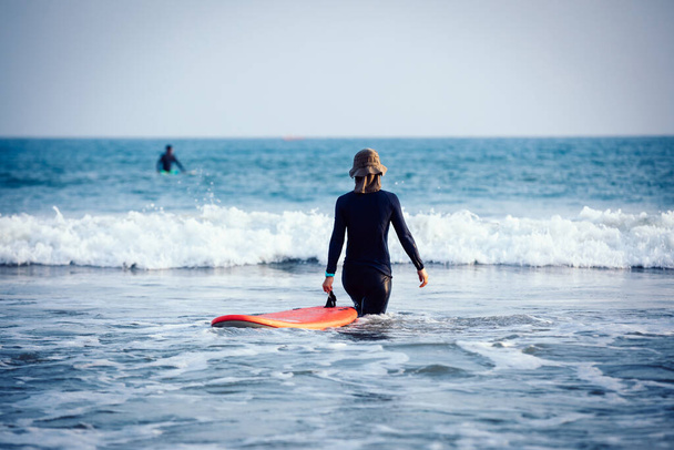 Surfer woman practice surfing in the white water - Foto, Bild