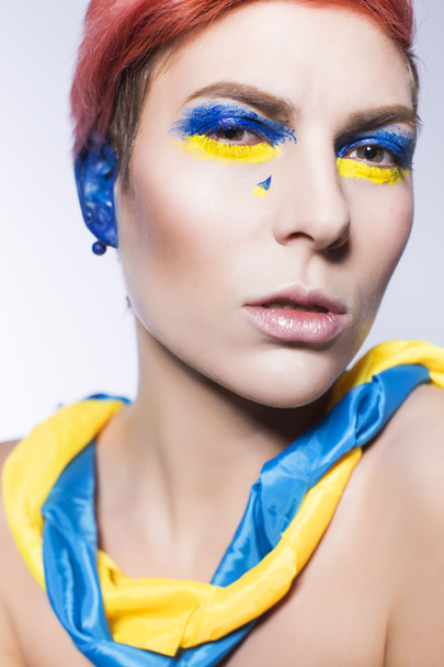 Young person closing ears and don't want to listen political lies crying. Ukrainian symbols and colors - 写真・画像