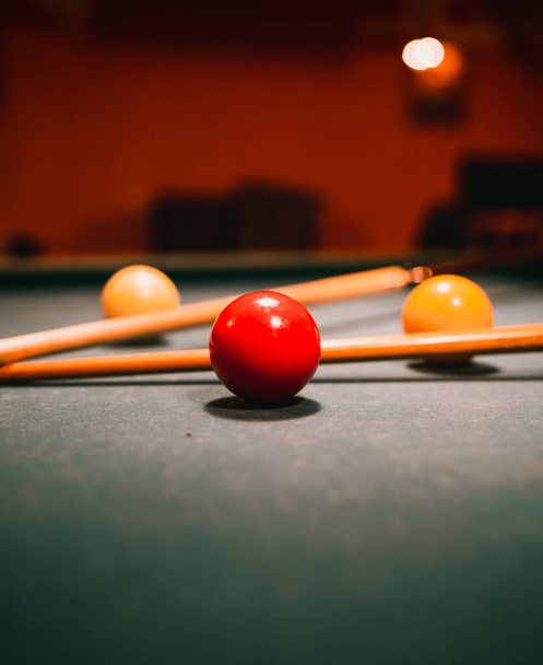A closeup view of the colorful balls and the wooden sticks for the pool table game - Fotografie, Obrázek