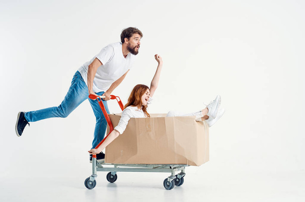 a young couple ride a cart entertainment isolated background - 写真・画像