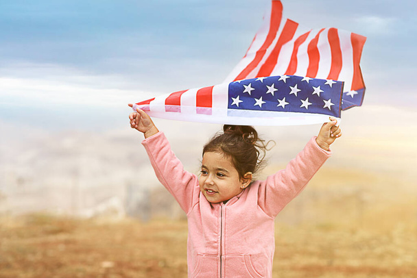Patriotic holiday. Happy kid, cute toddler child girl with American flag. USA celebrate 4th of July. - Photo, Image