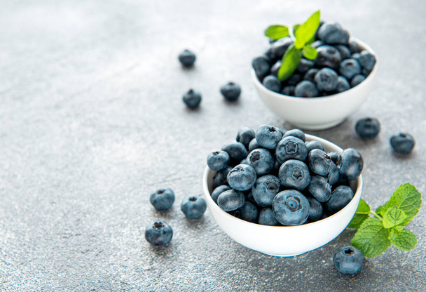 Freshly picked blueberries on a concrete background. Concept for healthy eating - Foto, Bild