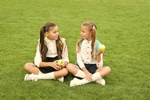 School students girls eating apples for lunch, eat healthy concept - Φωτογραφία, εικόνα
