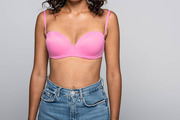 Cropped view of african american woman in pink bra isolated on grey - Photo, Image