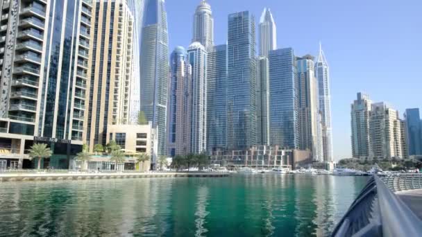 Dubai, UAE, 15.02.2021: Dubai Marina skyline with Marina Canal, modern skyscrapers, luxury hotels and yachts moored on the docks, swaying in the waves of the bay - Footage, Video