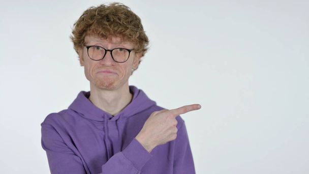 Copy space, Redhead Young Man Pointing with Finger on White Background - Photo, Image