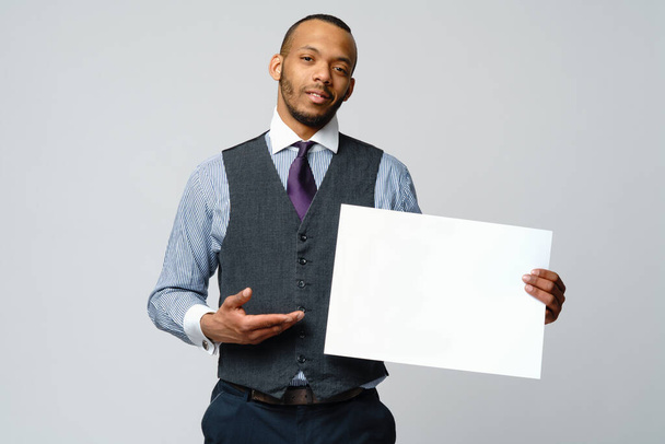 professional african-american business man - presenting holding blank sign - Valokuva, kuva