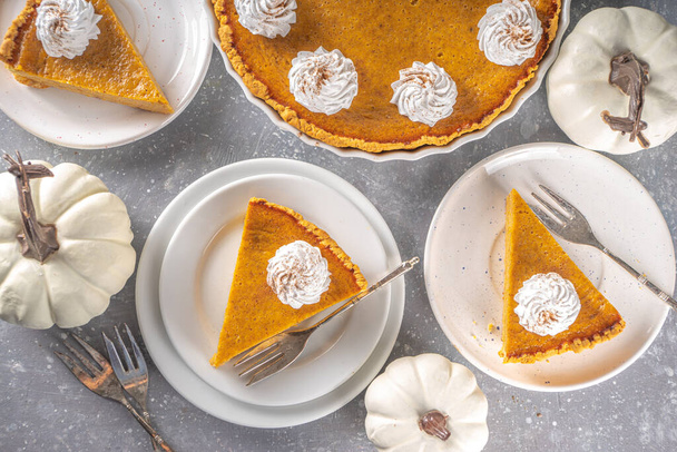 Traditional Autumn Pumpkin Pie. Homemade American Pumpkin pie topped with Whipped Cream.  - Fotó, kép
