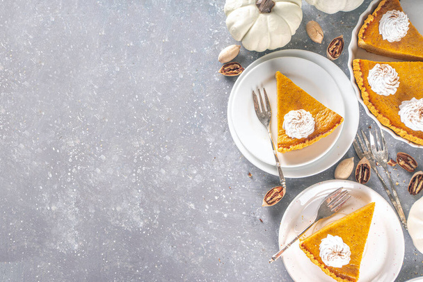 Traditional Autumn Pumpkin Pie. Homemade American Pumpkin pie topped with Whipped Cream.  - Photo, Image