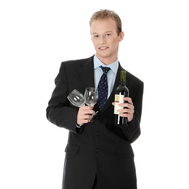 Young handsome businessman with bottle of wine - Foto, afbeelding