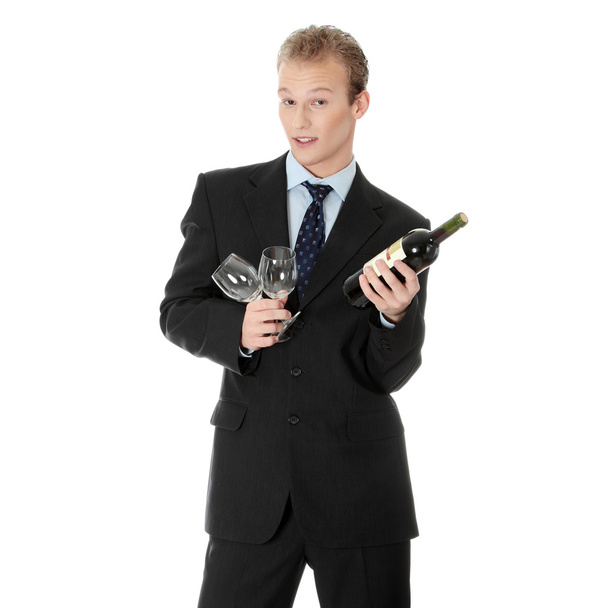 Young handsome businessman with bottle of wine - Fotoğraf, Görsel