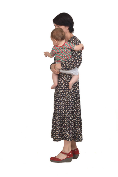 side view of a mother carrying her baby on white background - Photo, Image