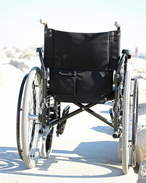 cadeira de rodas preta por trás com rodas de borracha
 - Foto, Imagem