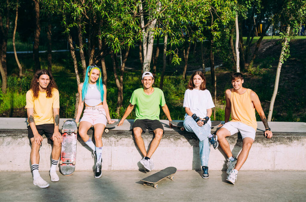 professional skateboarders having fun at the skate park - 写真・画像