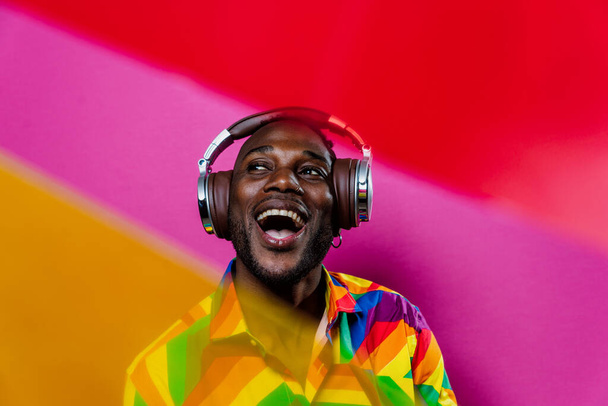 Artistic portrait with gel lights. Handsome man posing on colored backgrounds - Zdjęcie, obraz