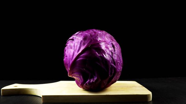 Fresh red cabbage (Brassica oleracea) on black background - Zdjęcie, obraz