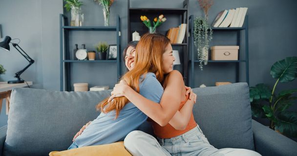 Happy Asian women teenager visit her close friends cuddling smiling at home. Overjoyed excited best buddies embracing hugging, greeting each other with success, true strong friendship concept. - Fotoğraf, Görsel