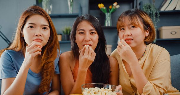 Attractive Asian lovely lady girl group positive glad cheerful with casual have fun and enjoy watch online movie entertainment on couch in living room at home. Lifestyle activity quarantine concept. - Photo, Image