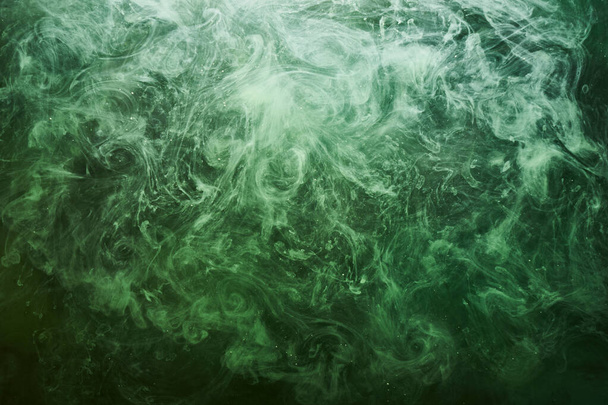 Abstract green color background. Swirling vibrant hookah smoke, underwater emerald ocean, dynamic paint in water - Foto, Bild