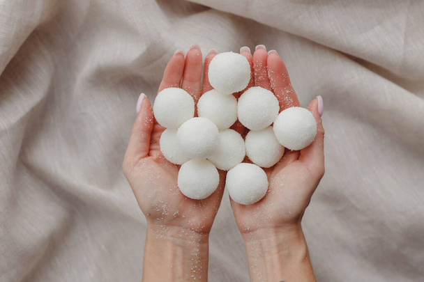 Les mains féminines tenant solide shampooing naturel fait à la main ou boules de gommage de sucre - Photo, image