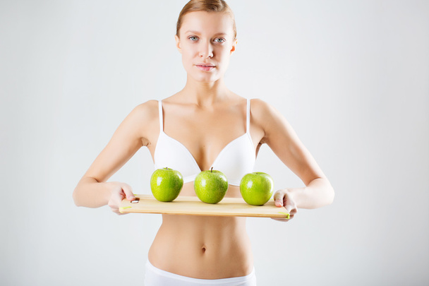 Girl with green apples in lingerie. concept of healthy eating - Foto, Bild