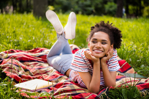 Full length body size photo female student laying on blanket in park smiling dreamy chilling on weekend - Photo, Image