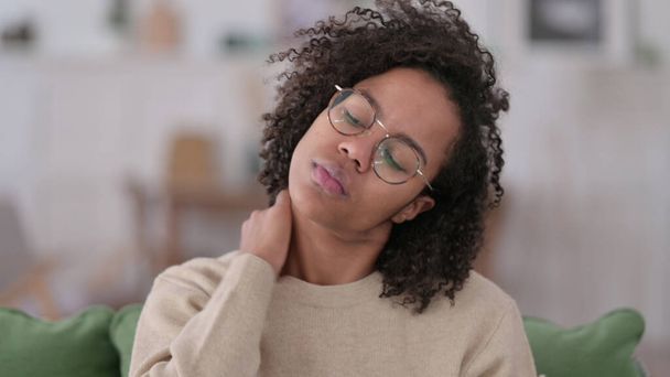 Young African Woman with Neck Pain at Home - Photo, Image
