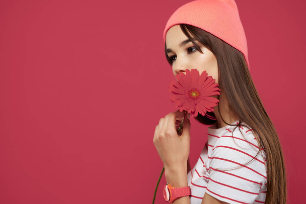 woman in pink hat red flower romance posing model - Фото, изображение