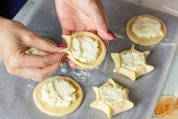 las manos de las mujeres esculpir pasteles de queso cuajada. El proceso de hacer masa de pastel a mano - Foto, Imagen