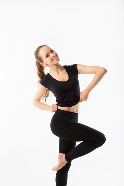 Fitness girl standing on one leg - Foto, Imagen