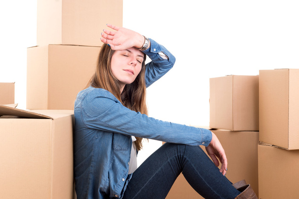 Tired girl with cardboard boxes - Foto, imagen