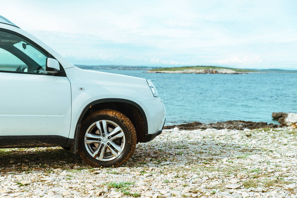 car travel concept suv at seaside with dirty wheels. road trip concept - Photo, Image